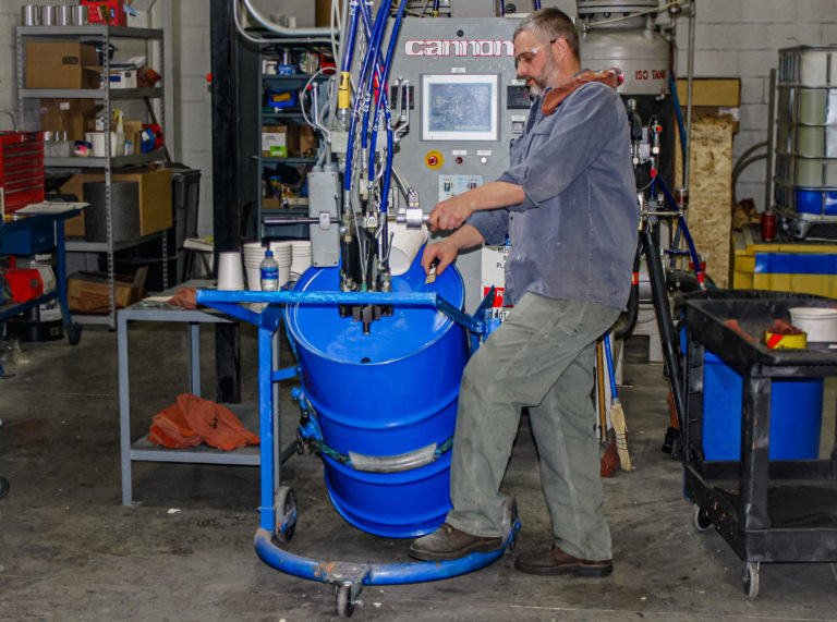 Paragon employee filling blue barrel